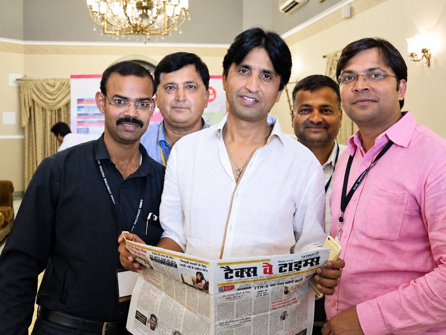 Group photograph with a newspaper